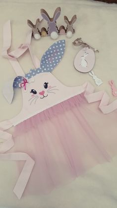 a pink tutu skirt with white polka dots and bunny ears on it, along with other accessories