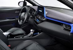 the interior of a car with black leather and blue trims, including steering wheel