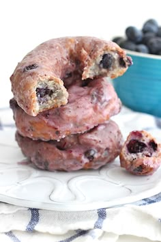 three blueberry donuts stacked on top of each other