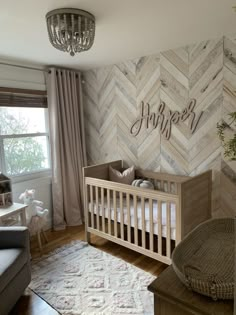 a baby's room with chevroned walls and a crib