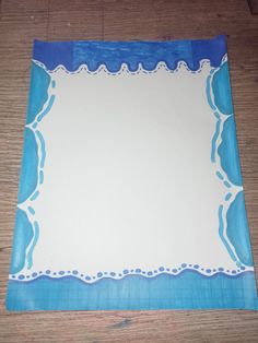 a blue and white place mat on top of a wooden table