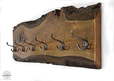 a wooden plaque with hooks attached to it