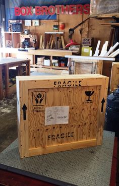 a wooden box sitting on top of a table in a room filled with other boxes