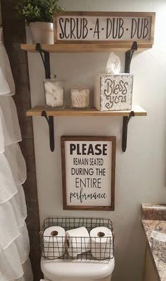 a bathroom with two shelves above the toilet and a sign that says scrub - a - dubb - dubb