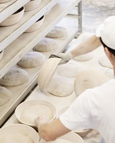 a man is making bread in a bakery