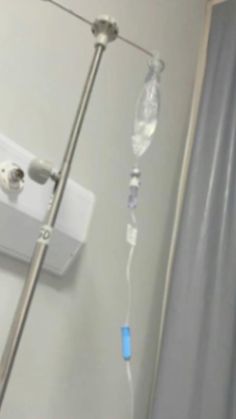 a hospital room with an oxygen tube attached to the wall