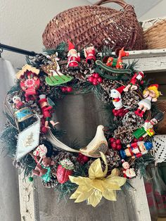 a christmas wreath on top of a window sill next to a basket and other items