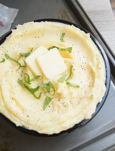 a pan filled with mashed potatoes and butter