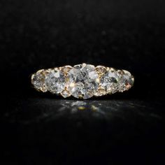 three stone diamond ring on black background