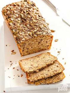 sliced loaf of bread sitting on top of a white cutting board