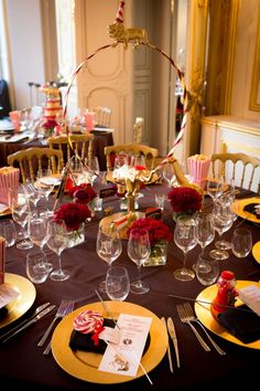 the table is set with wine glasses, candy canes, and other decorative items