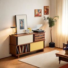 a living room with a couch, coffee table and pictures on the wall