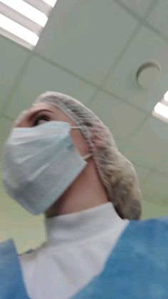 a person wearing a surgical mask while standing in a room