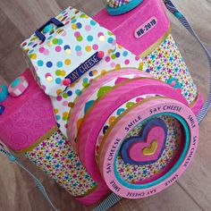 a pink toy camera sitting on top of a wooden floor