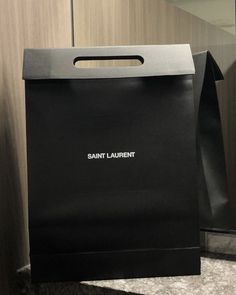 a black paper bag sitting on top of a counter