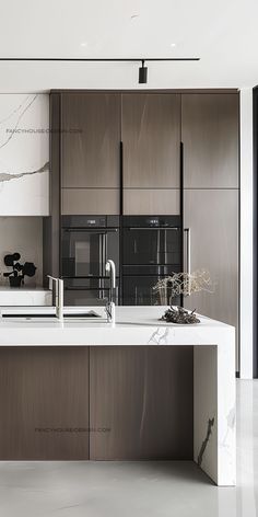 a modern kitchen with marble counter tops and stainless steel appliances