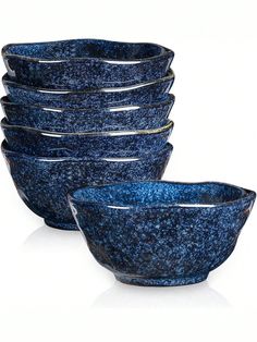 blue speckled bowls stacked on top of each other in front of a white background