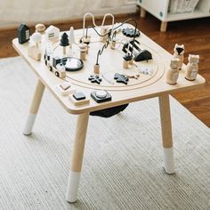 a wooden table topped with lots of different types of items on top of each other