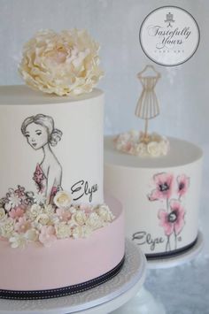 two cakes decorated with flowers on top of each other and one has a woman's face painted on it