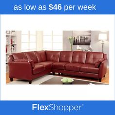 a red leather sectional sofa sitting on top of a wooden floor