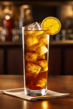 a tall glass filled with ice and lemon slices