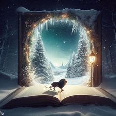 an open book with the image of a lion on it in front of snow covered trees