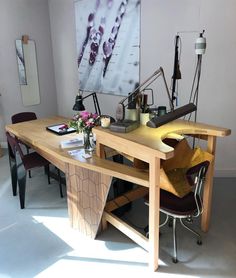 a wooden table with chairs around it in a room