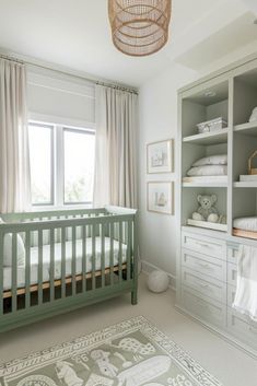 a baby's room with white and green decor