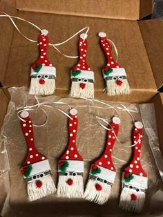 christmas decorations made to look like santa's hats and brooms in a box