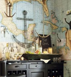 a kitchen with a map on the wall and lots of bottles in front of it