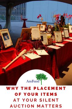 there are many items on the table with red cloths and white writing that says why the placement of your items at your silent auction matters