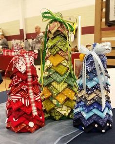 three small christmas trees made out of fabric