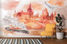 a wall mural with hogwart's castle in the background and a train going by