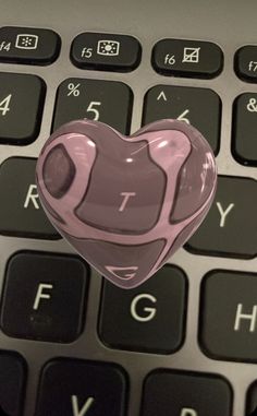 a heart shaped sticker sitting on top of a keyboard