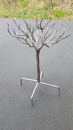 a small metal tree sitting on top of a road