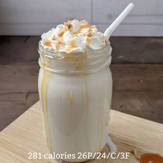 there is a drink with whipped cream on the top and caramel in the bottom