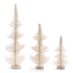 three small white christmas trees on a white background