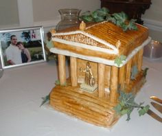 a small wooden shrine on a table with two pictures and utensils next to it