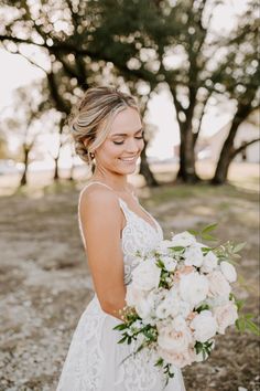 a woman in a wedding dress holding a bouquet