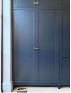 a tall blue cabinet in the corner of a room