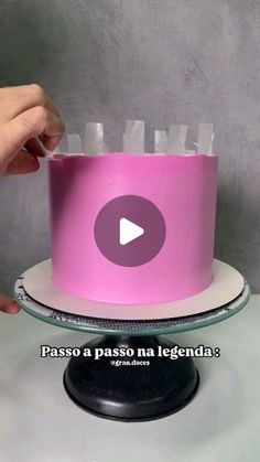 a pink cake sitting on top of a table