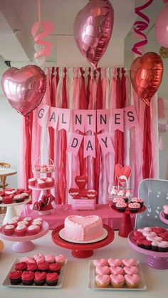 valentine's day dessert table with cupcakes, cake and heart shaped balloons