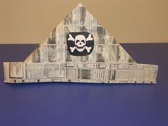 a paper cut out of a building with a skull and crossbones on it