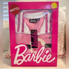 a barbie doll in a pink box with clothes