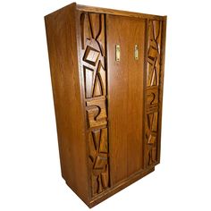 a wooden cabinet with carved designs on the front and side doors, made out of wood