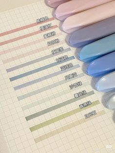 several different colors of toothbrushes lined up next to each other on a sheet of paper