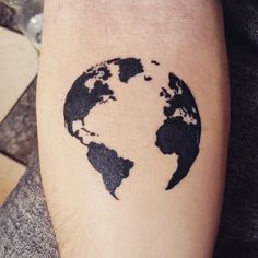 a black and white world map tattoo on the arm