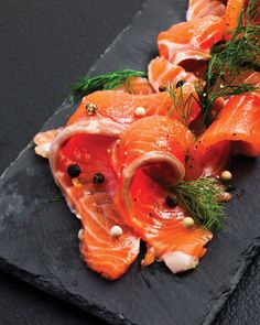 smoked salmon with herbs and spices on a slate platter