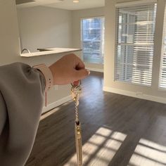 a person holding a key in an empty room