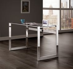 an office desk with a glass top and metal legs, in front of a large window